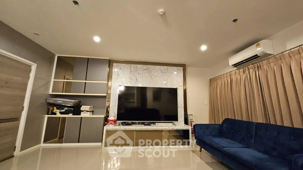 Modern living room with marble TV wall and blue velvet sofa