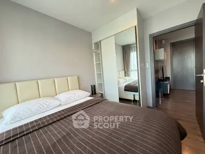 Cozy bedroom with modern decor and ample natural light