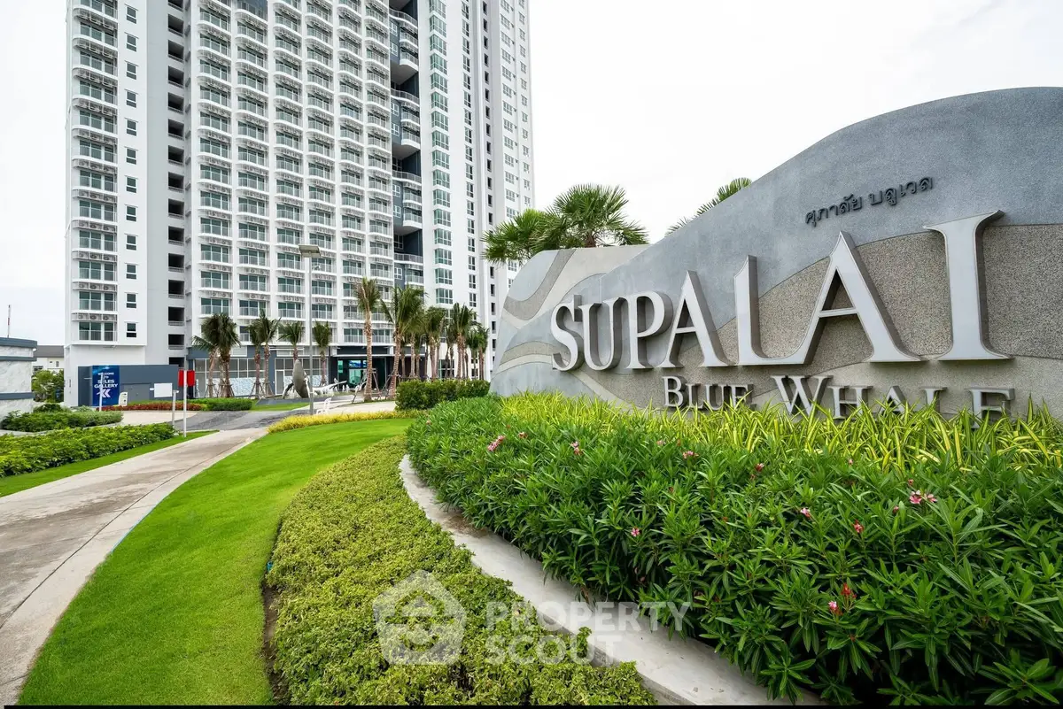 Modern high-rise building with lush landscaping at Supalai Blue Whale.