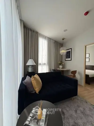 Modern living room with elegant decor and cozy seating area, perfect for relaxation and entertaining.