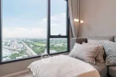 Luxurious living room with panoramic city view and cozy seating area.