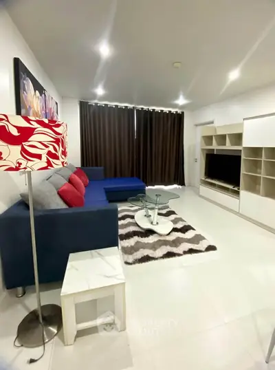 Modern living room with stylish decor, cozy sofa, and entertainment center in a contemporary apartment.