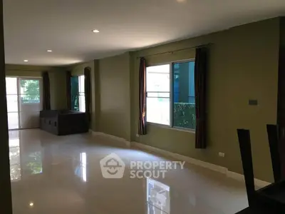 Spacious living room with large windows and modern decor