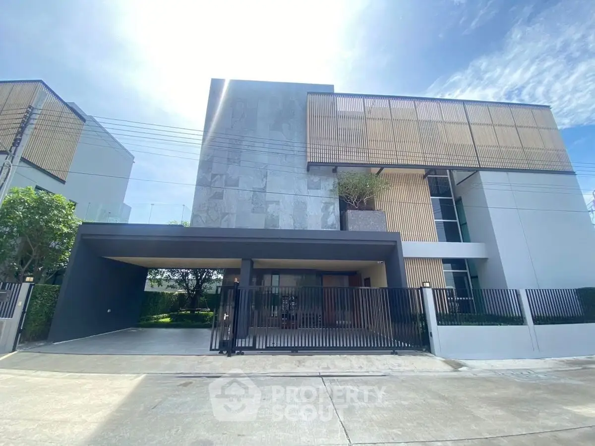Modern architectural masterpiece with sleek facade and spacious driveway in a serene neighborhood.