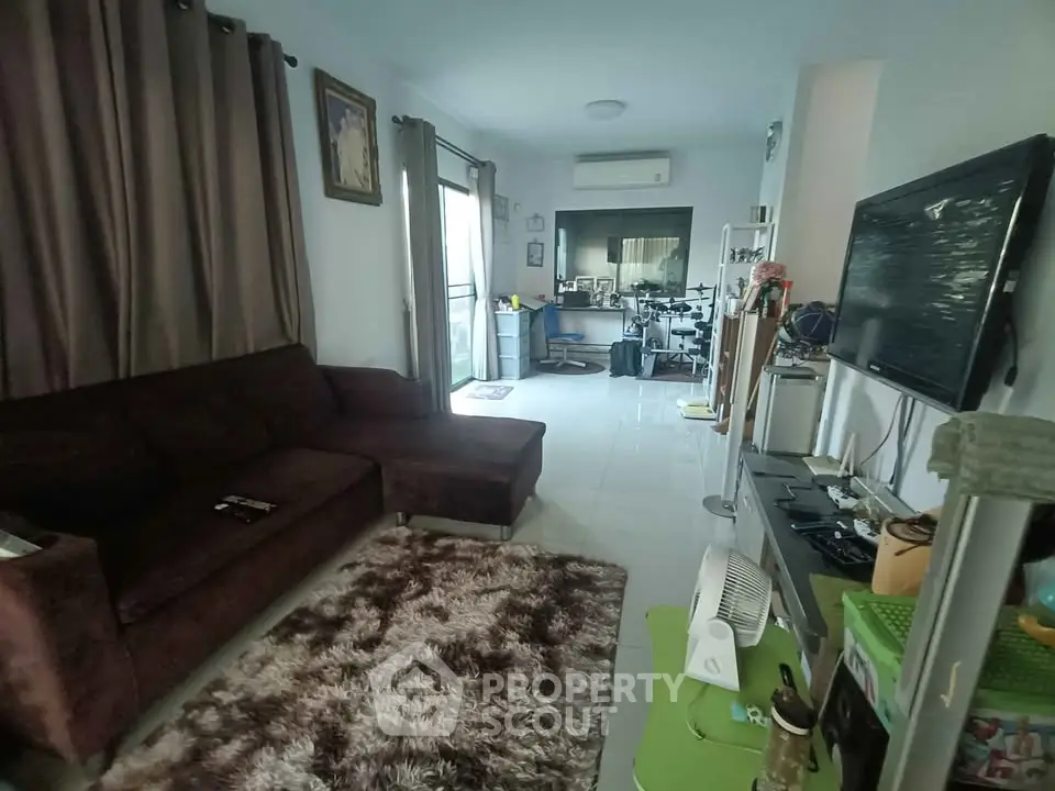 Spacious living room with modern decor and large windows for natural light.