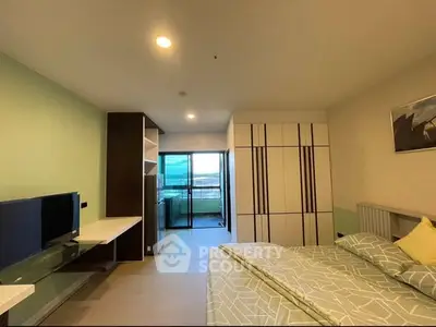 Modern bedroom with balcony view and stylish decor in a contemporary apartment.