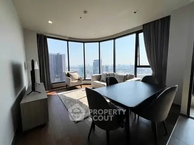 Spacious living room with panoramic city views and modern furnishings