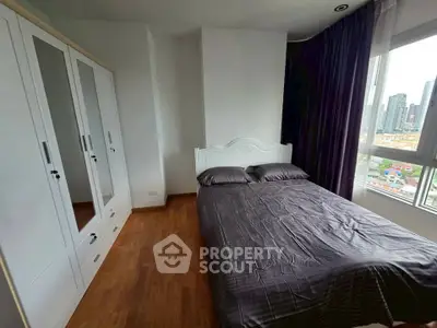 Modern bedroom with city view, featuring sleek wardrobe and cozy bed in high-rise apartment.