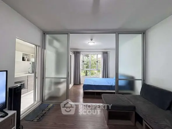 Modern studio apartment with sliding glass doors and cozy furnishings