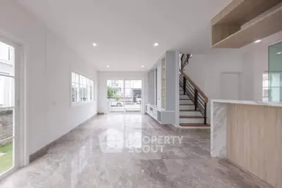 Spacious modern living room with marble flooring and large windows