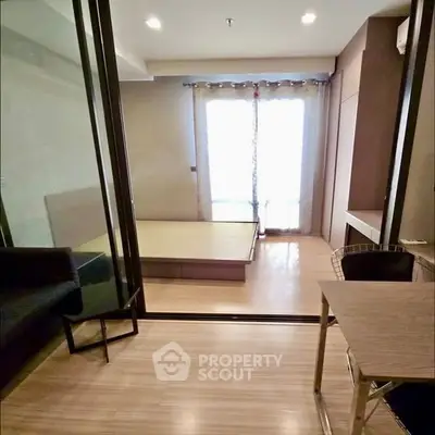 Modern studio apartment with glass partition and wooden flooring