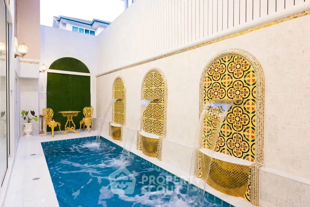 Luxurious private pool with elegant tile design and ornate seating area, perfect for relaxation and entertainment.