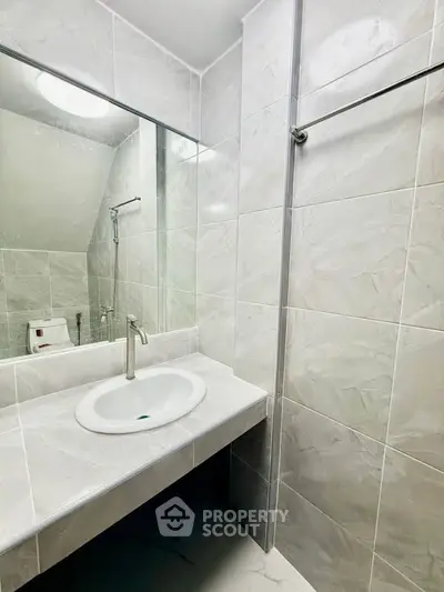 Modern bathroom with sleek marble tiles and elegant sink design