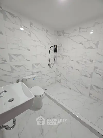 Modern bathroom with marble tiles and sleek fixtures