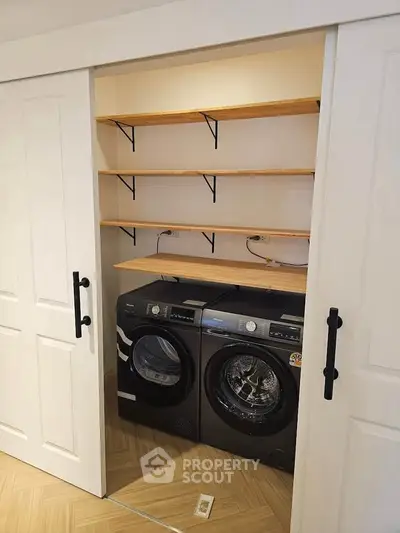 Modern laundry area with washer and dryer in a compact closet space.