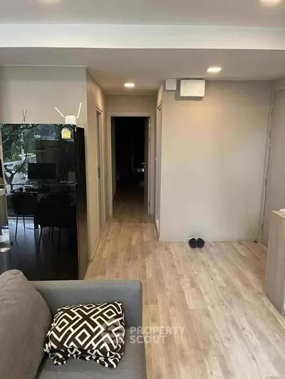 Modern apartment interior with stylish decor and open layout, featuring a cozy living area and sleek flooring.