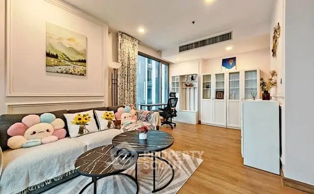 Stylish living room with modern decor, cozy seating, and natural light in a contemporary apartment.