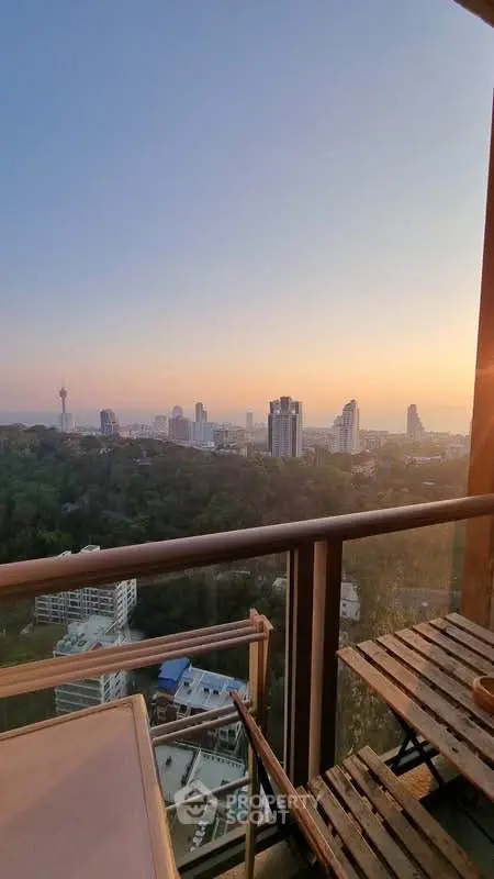 Stunning high-rise balcony view overlooking city skyline at sunset, perfect for urban living enthusiasts.