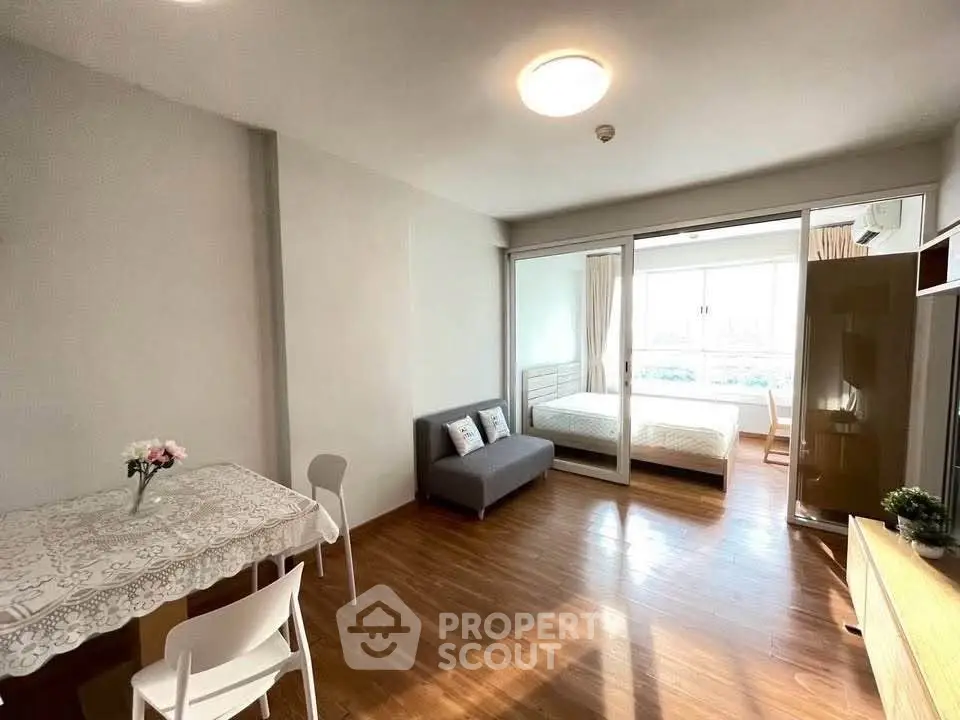 Spacious studio apartment with wooden flooring and natural light