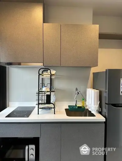 Sleek modern kitchen with built-in appliances and ample storage, featuring a clean design with a minimalist aesthetic, perfect for urban living.