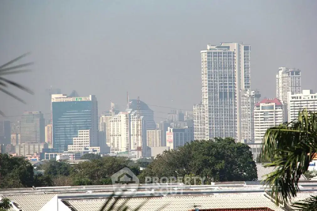 Stunning city skyline view with modern high-rise buildings and lush greenery, perfect for urban living enthusiasts.