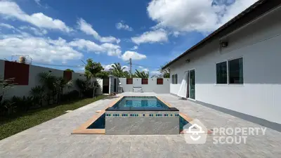 Stunning backyard with modern pool and lush garden in serene residential area.