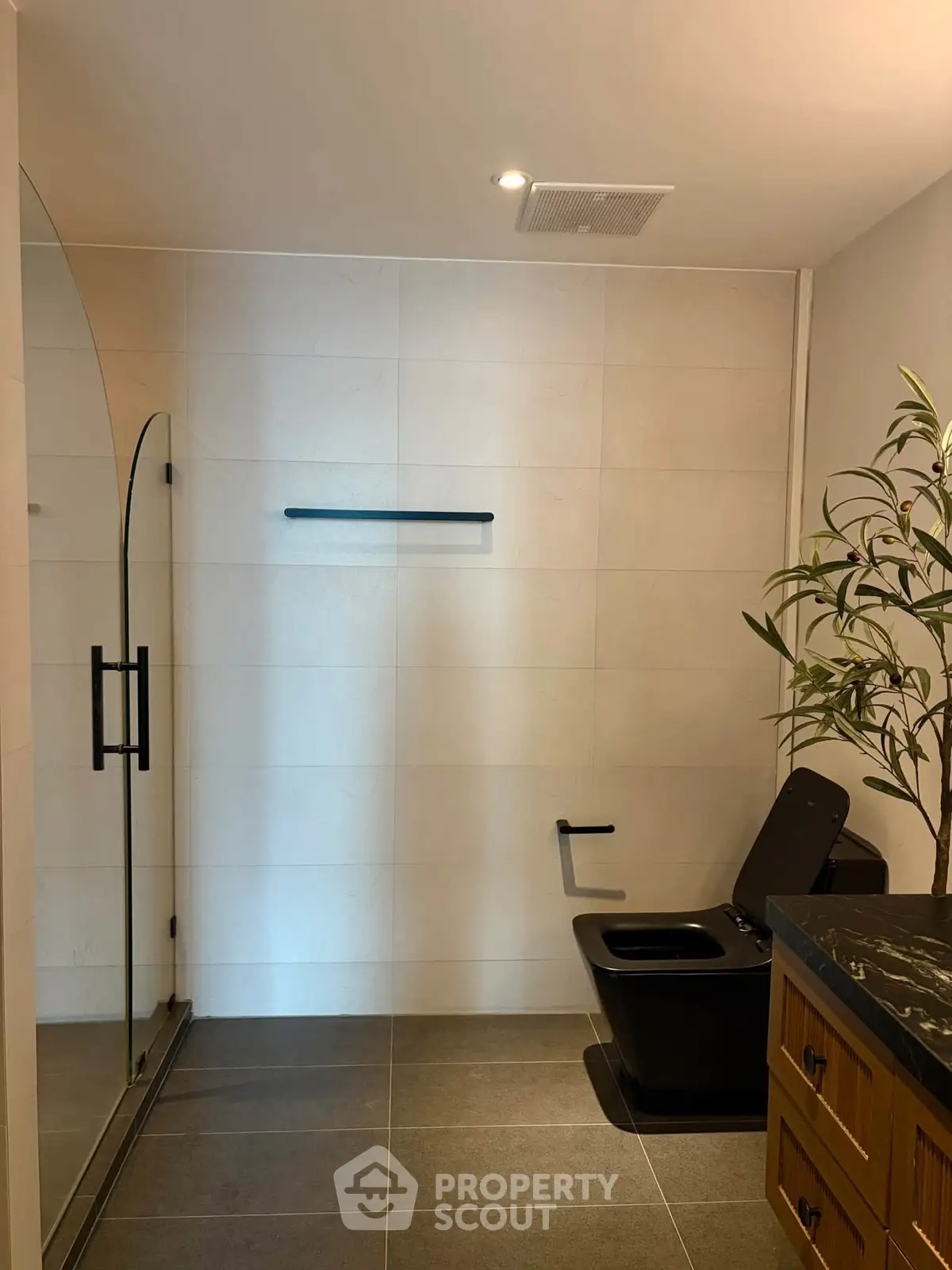 Modern bathroom with sleek black fixtures and glass shower enclosure
