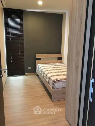 Cozy bedroom with modern wooden bed and sleek blinds, perfect for restful nights.