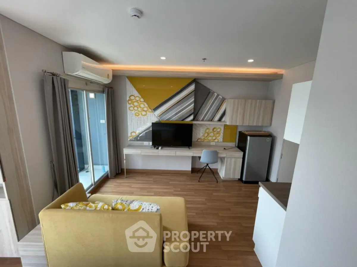 Modern living room with stylish decor and balcony access