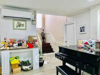 Charming living room with piano and staircase, perfect for music lovers and cozy gatherings.