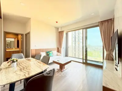 Modern living room with marble dining table and balcony view in luxury apartment.
