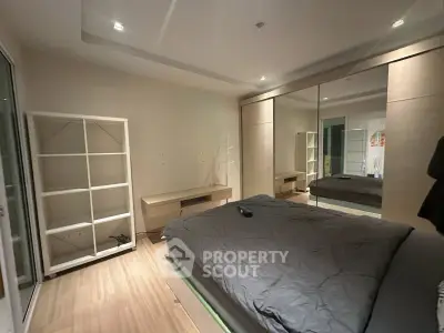 Modern bedroom with mirrored wardrobe and sleek design