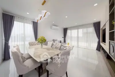 Elegant modern living room with marble dining table and plush seating