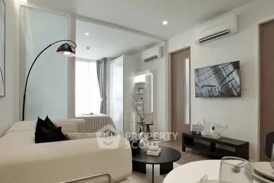 Modern living room with sleek furniture and air conditioning in a stylish apartment.