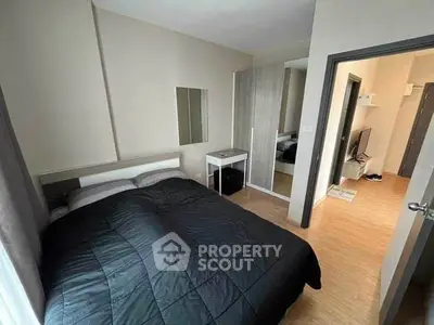 Cozy bedroom with modern decor and mirrored wardrobe in a stylish apartment.