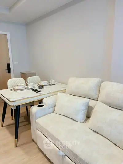 Modern living room with elegant dining table and cozy sofa in a stylish apartment.