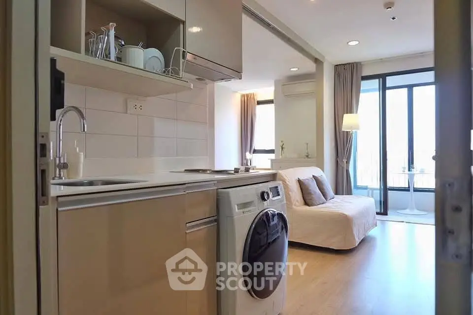 Modern studio apartment with compact kitchen and cozy living area