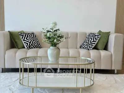 Elegant living room with modern sofa and stylish glass coffee table, perfect for contemporary homes.