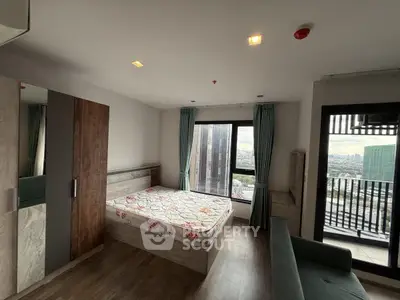 Modern bedroom with city view and balcony access