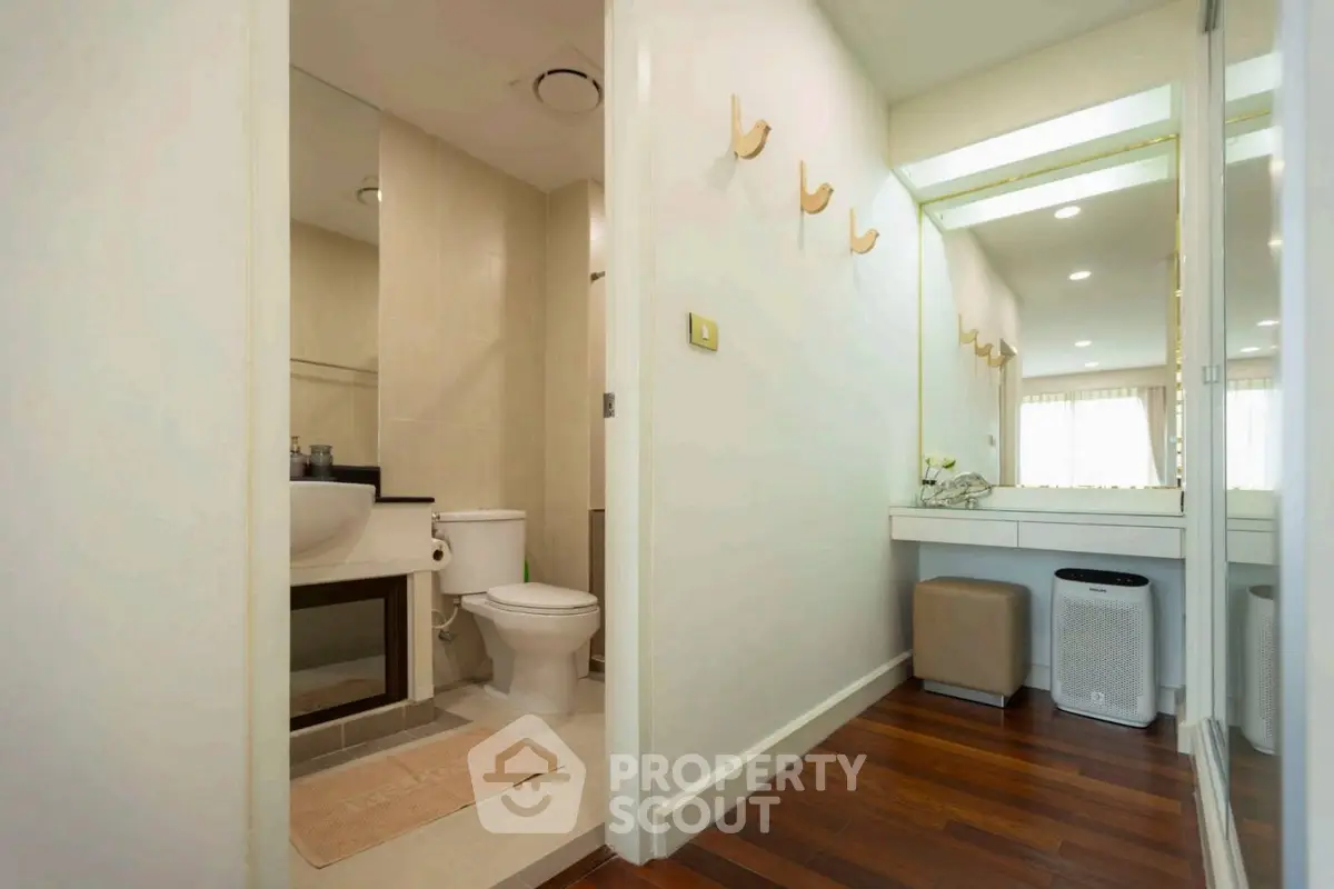 Modern bathroom with elegant vanity and wooden flooring