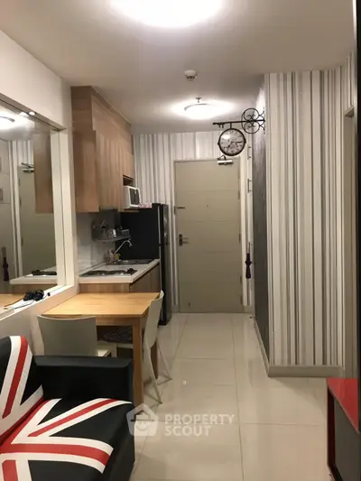 Modern apartment interior with stylish kitchen and dining area, featuring unique decor and compact design.