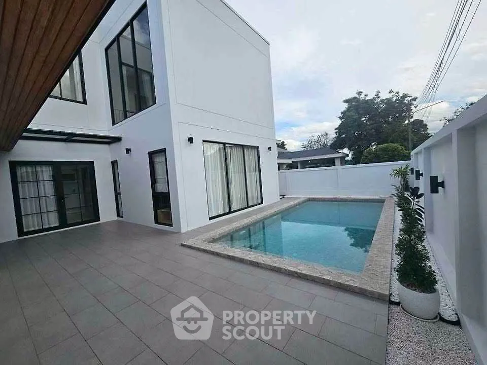 Modern minimalist home with private pool and spacious patio area.