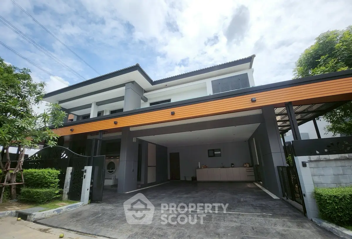Modern two-story house with spacious driveway and sleek design