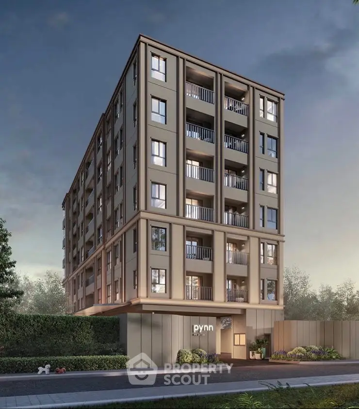 Modern apartment building exterior with balconies and lush greenery, perfect for urban living.