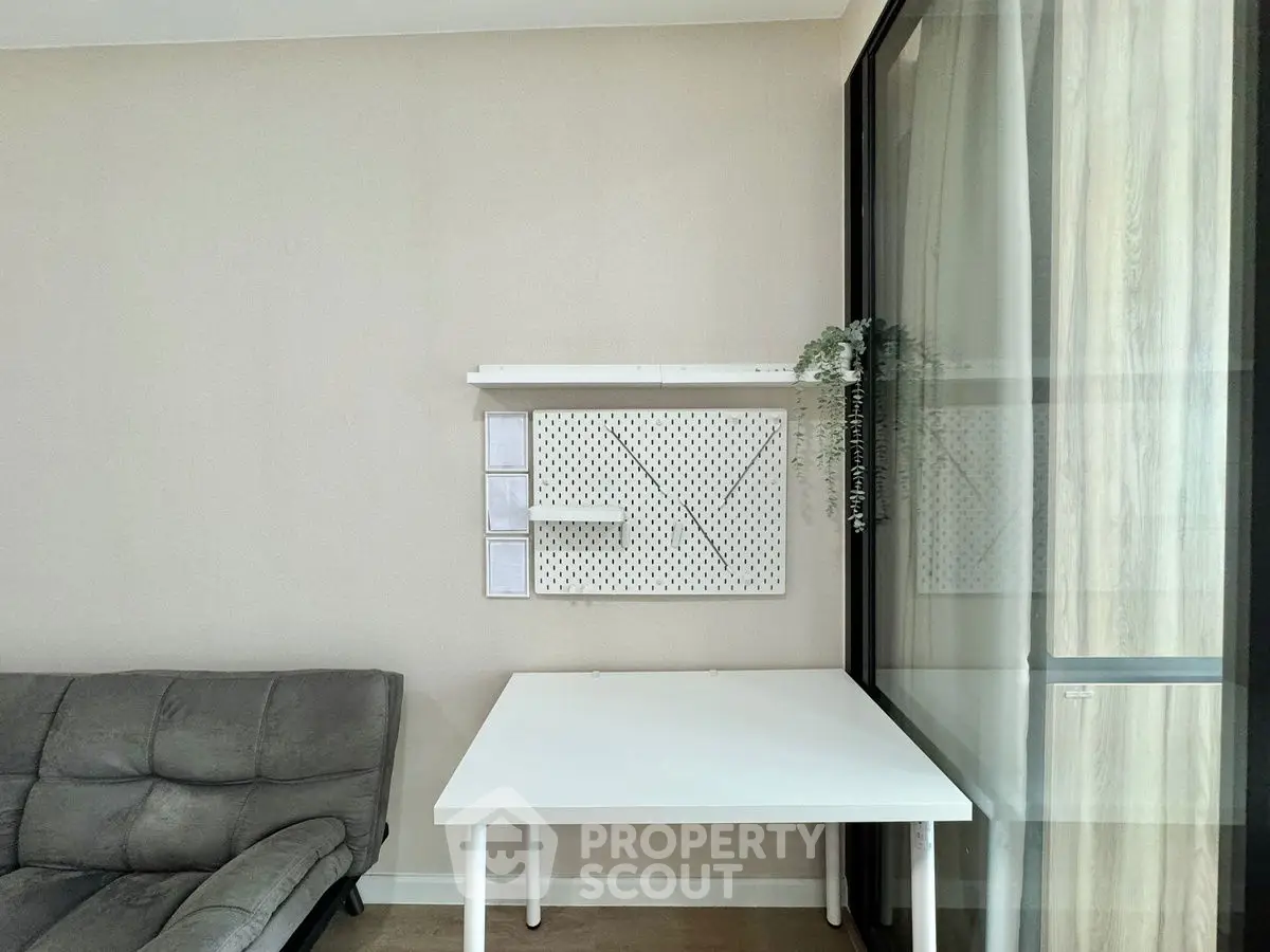 Modern minimalist living area with sleek furniture and wall-mounted storage solutions.