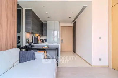 Modern open-layout kitchen and living room with sleek design and cozy ambiance.