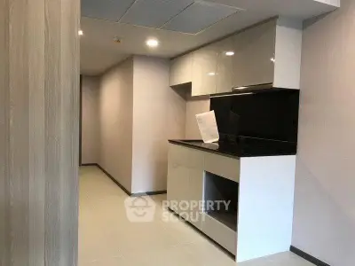 Modern kitchen with sleek cabinetry and glossy finishes in a contemporary apartment.