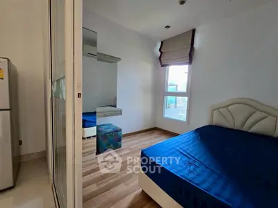 Cozy bedroom with modern decor and natural light, featuring a comfortable bed and stylish furnishings.