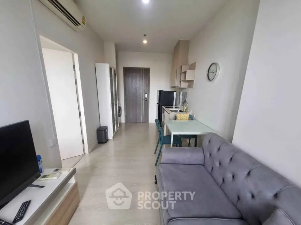 Modern apartment interior with cozy living area and compact kitchen