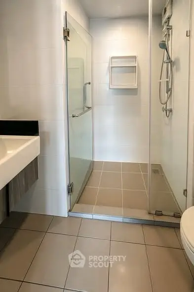 Modern bathroom with glass shower and sleek tile flooring